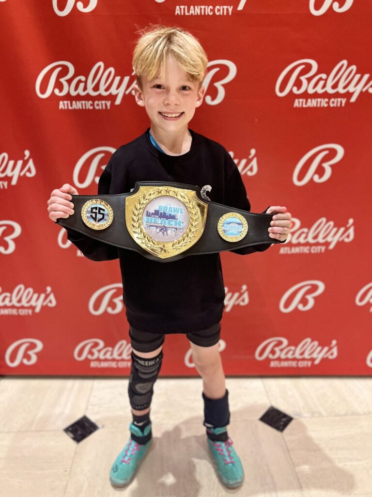 Jordan holding his Brawl at the Beach Open champion belt