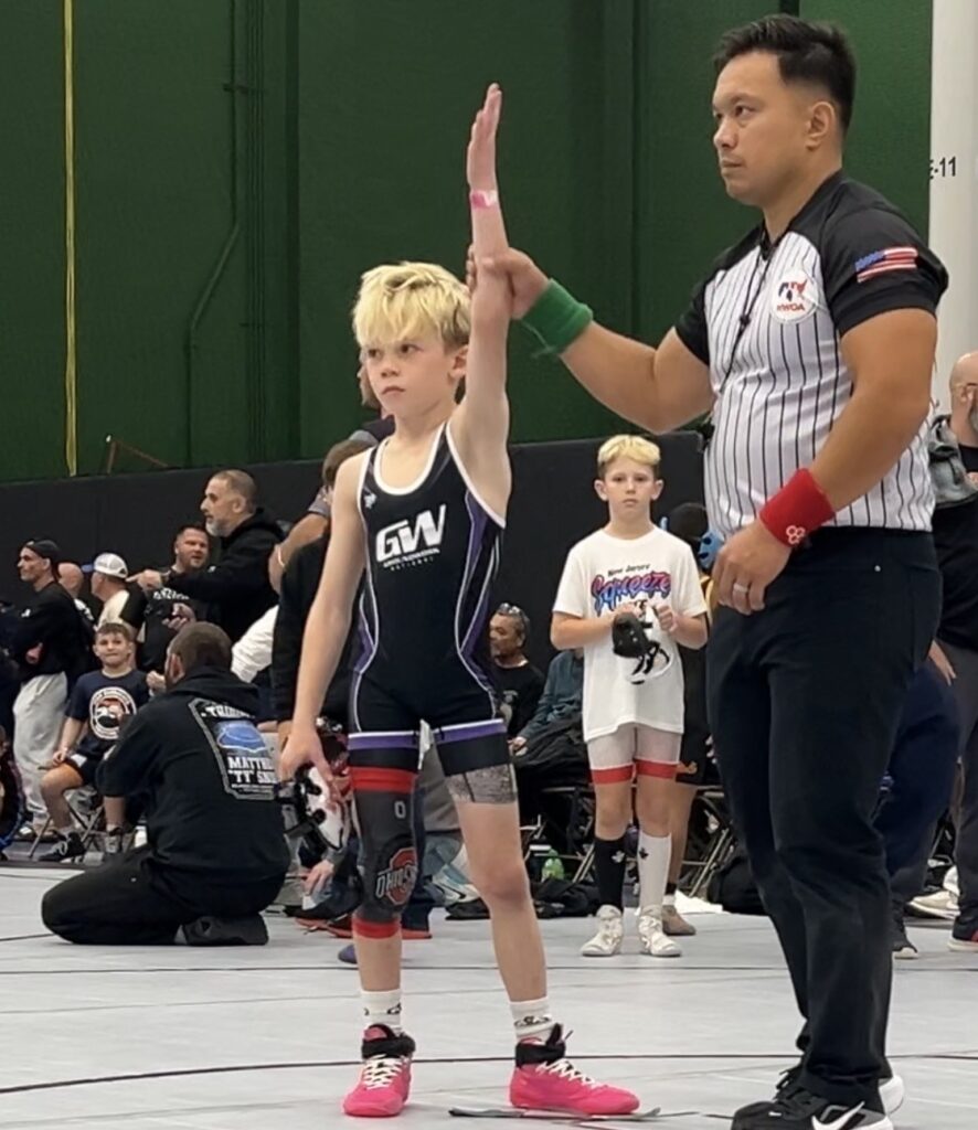 Jordan getting his hand raised at the Columbus Day Duals