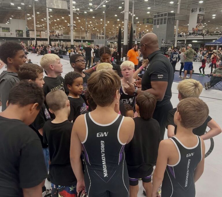Groundwork wrestlers huddled with their coach