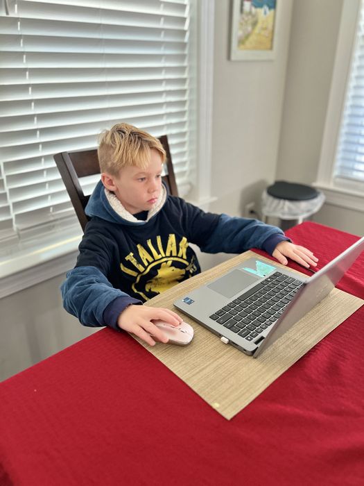 Jordan at the computer setting his fantasy football lineup
