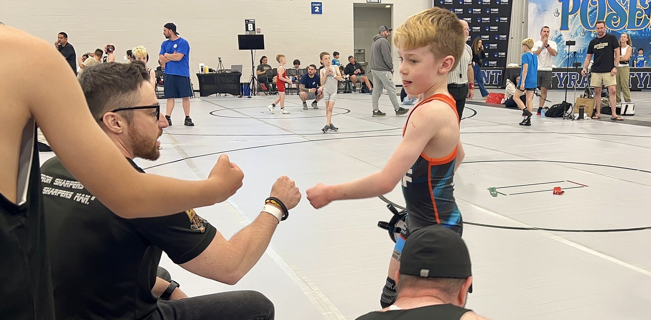 Jordan fist-bumping his coach mat-side at a tournament