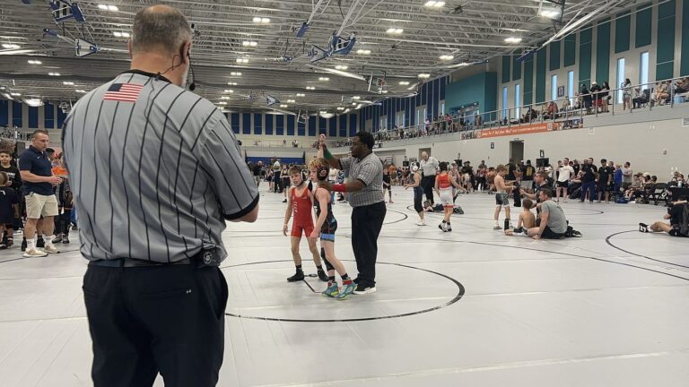 Jordan getting his hand raised at the Poseidon Duals
