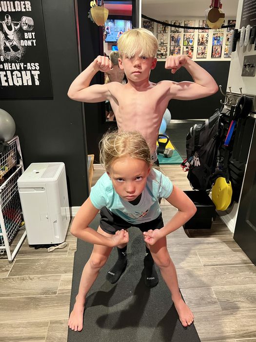 Jordan and Saylor flexing in the home gym