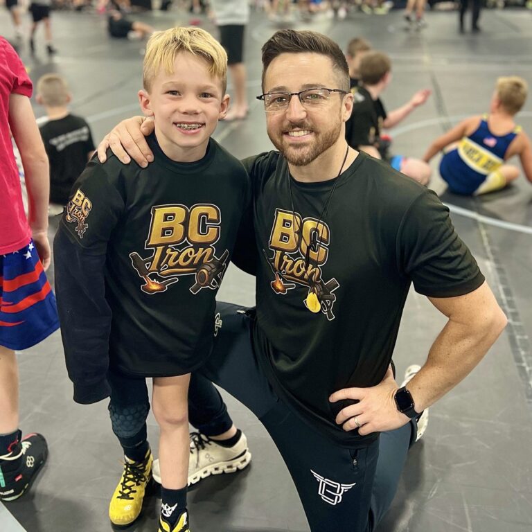 Jordan and his dad in BC Iron shirts at Tyrant Nationals