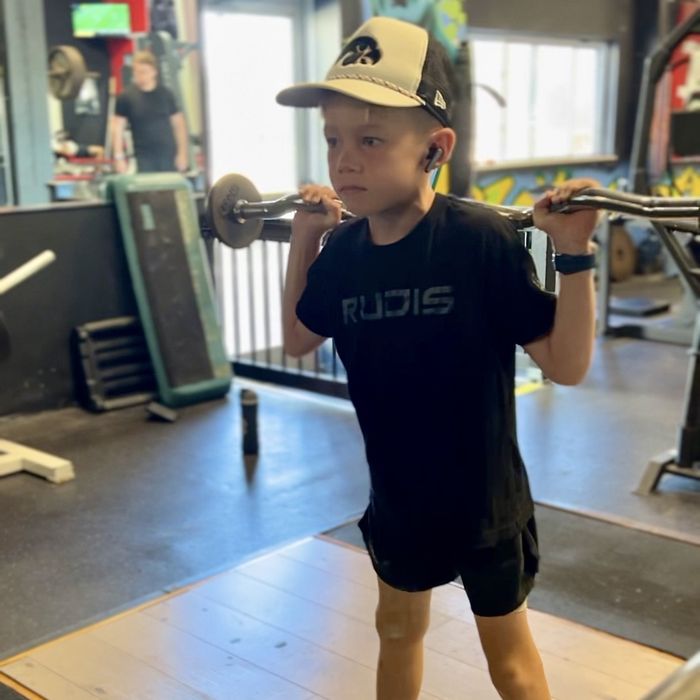 Jordan lifting a bar in the gym